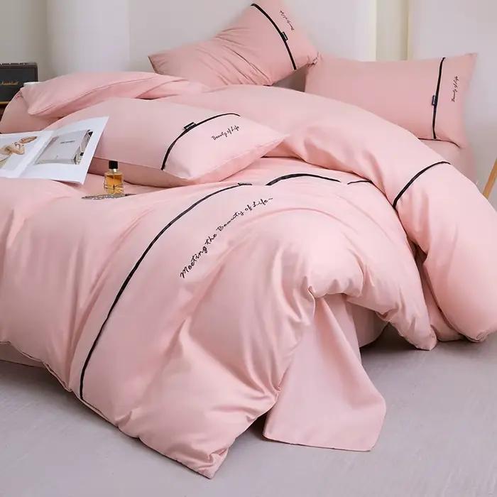 Nouvel ensemble de draps et de draps-housses 4 pièces en coton lavé doux pour la peau, couleur unie, avec ruban brodé et double bordure