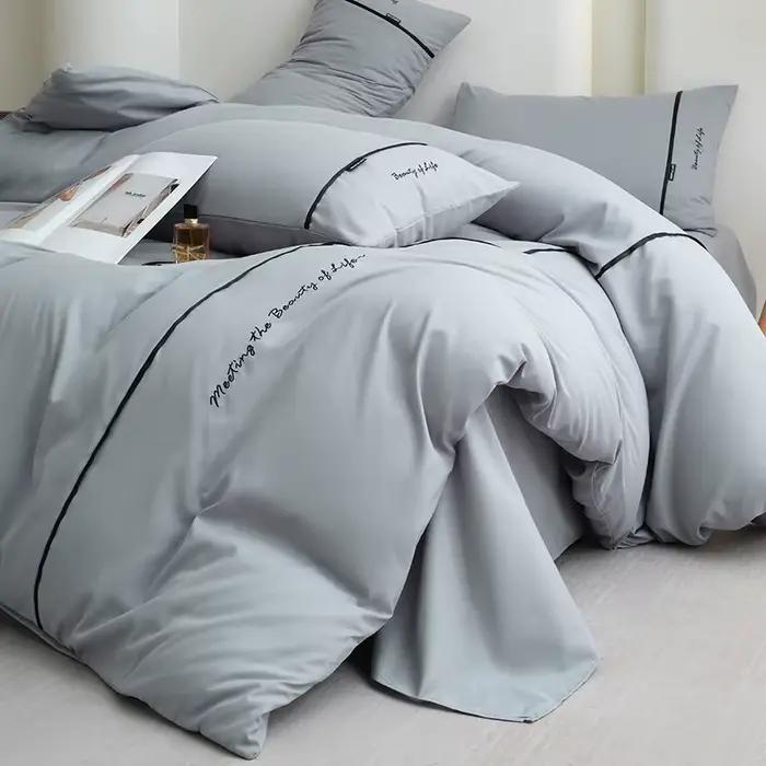 Nouvel ensemble de draps et de draps-housses 4 pièces en coton lavé doux pour la peau, couleur unie, avec ruban brodé et double bordure