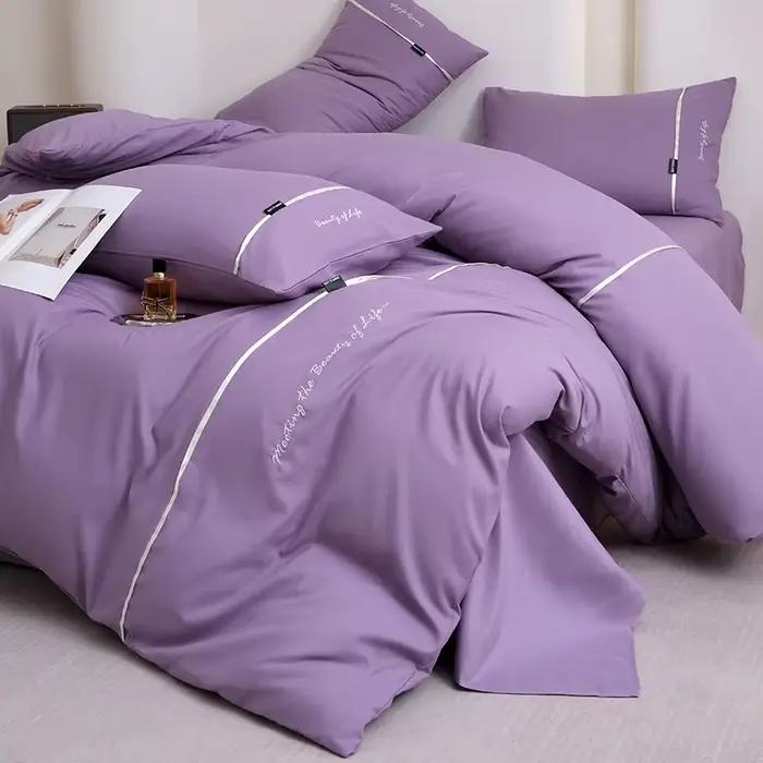 Nouvel ensemble de draps et de draps-housses 4 pièces en coton lavé doux pour la peau, couleur unie, avec ruban brodé et double bordure